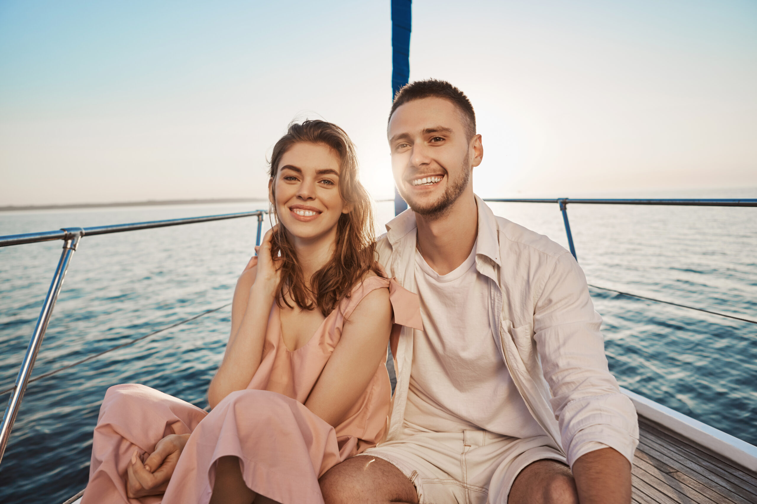 romantic-couple-smiling-while-sitting-bow-boat-hugging-enjoying-their-holidays